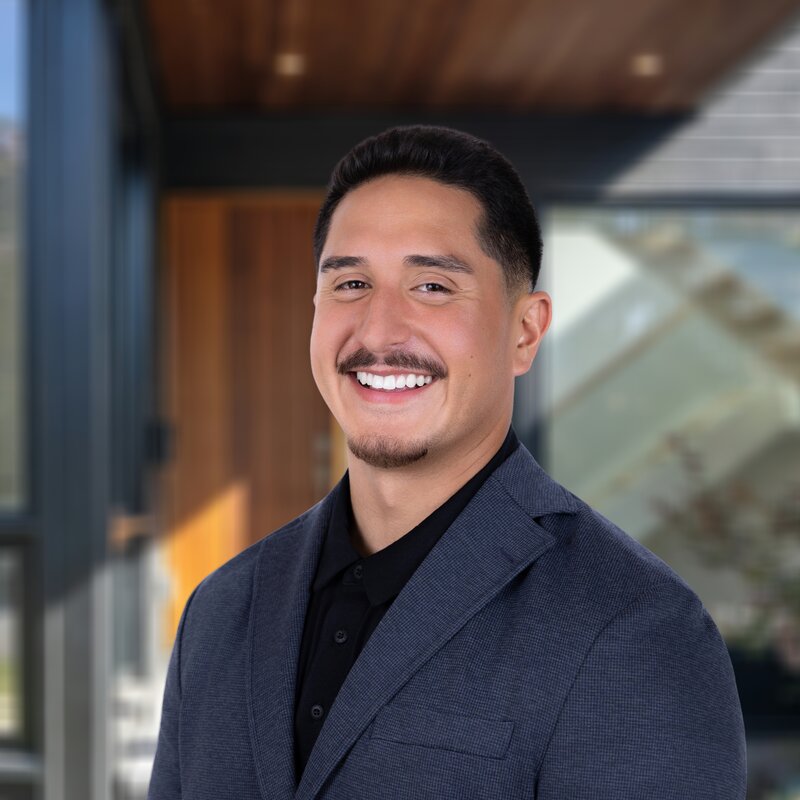 Headshot of Nate Johnson, Construction Manager at Sovereignty Construction, in a gray blazer.
