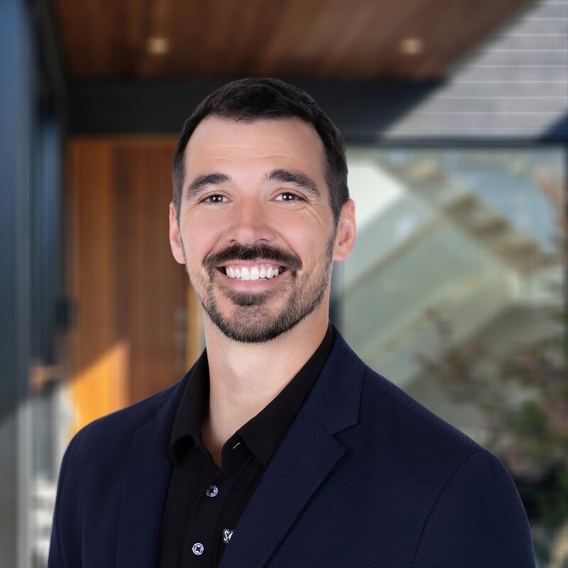 Headshot of Garrett Pewe, Vice President & COO of Sovereignty Construction, in a dark blazer.